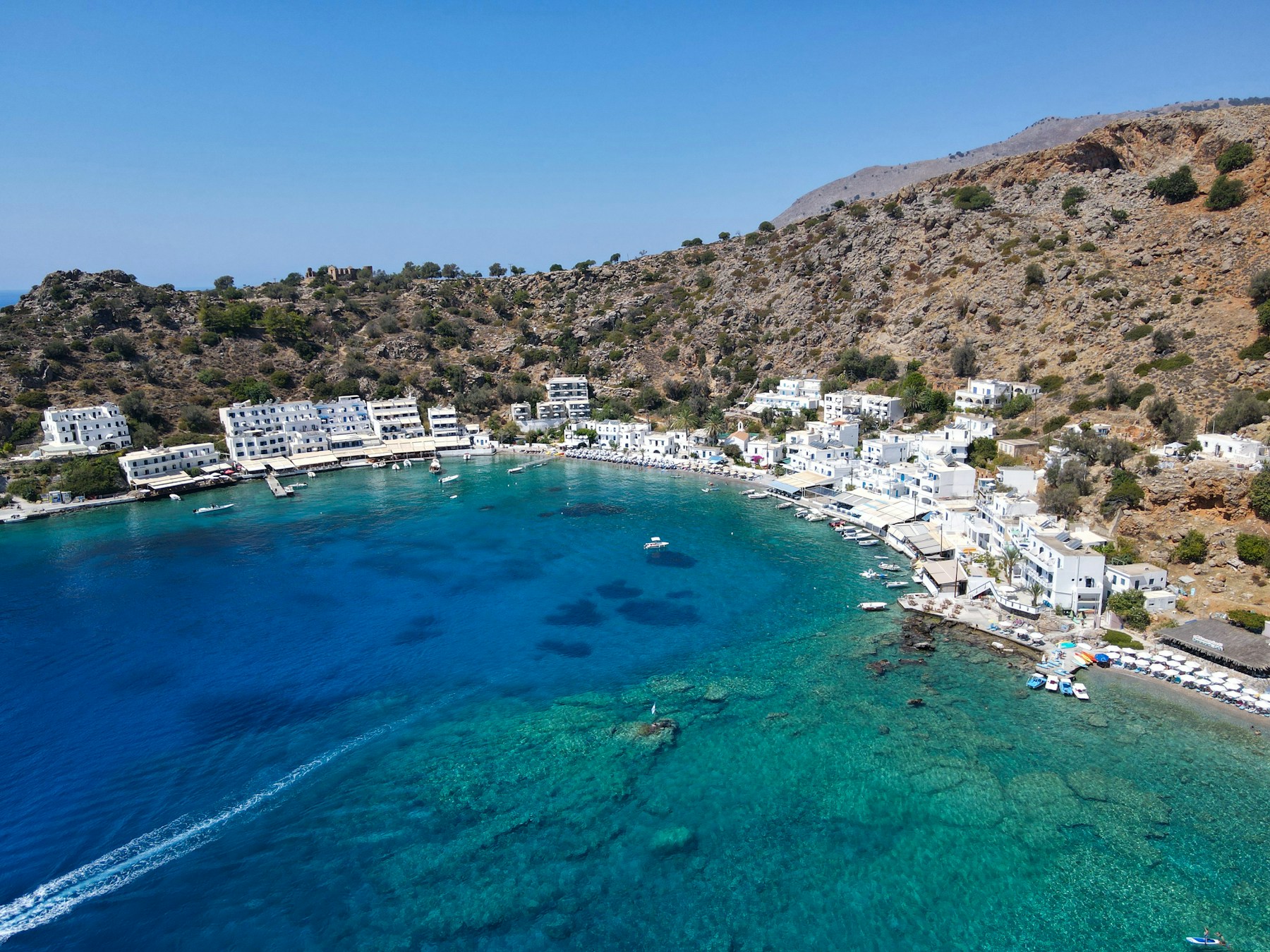 Klares, türkisblaues Wasser an einem flachen Sandstrand, ideal für den Badeurlaub auf Kreta mit Kindern